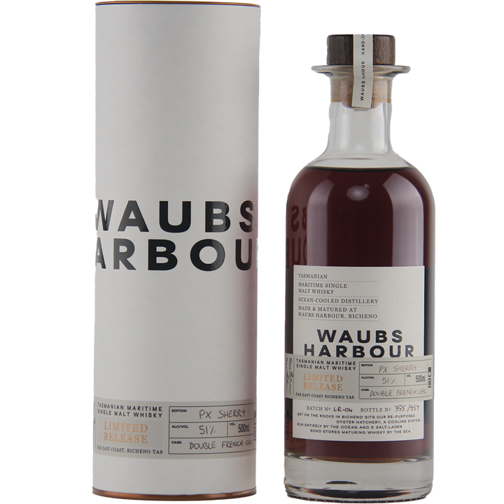 A bottle of Waubs Harbour PX Sherry Cask Single Malt Australian Whisky, dark amber in color, stands beside its white cylindrical box featuring bold black lettering and a detailed white label with black text.