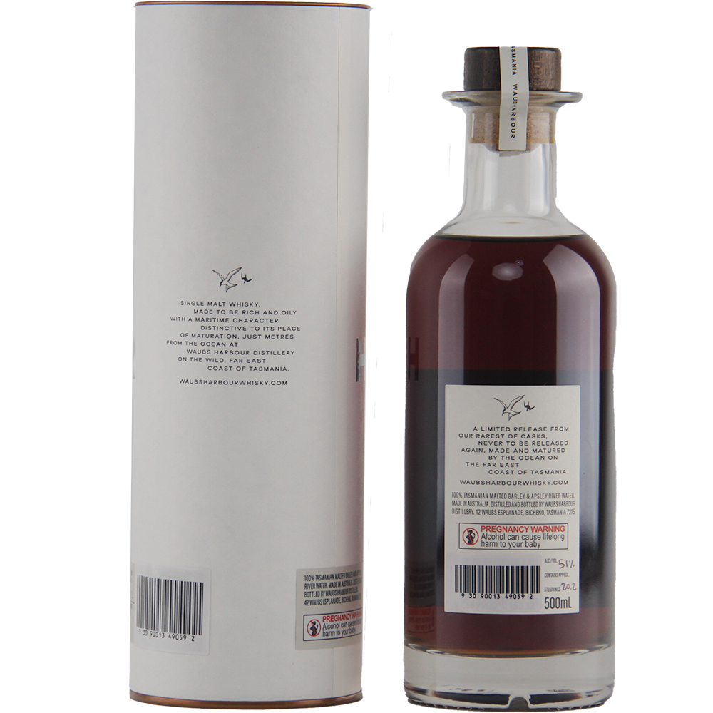 A bottle of Waubs Harbour PX Sherry Cask Single Malt Australian Whisky with a wax-sealed cork stands next to its cylindrical white box. Both labels detail the whisky and display barcodes near the bottom.