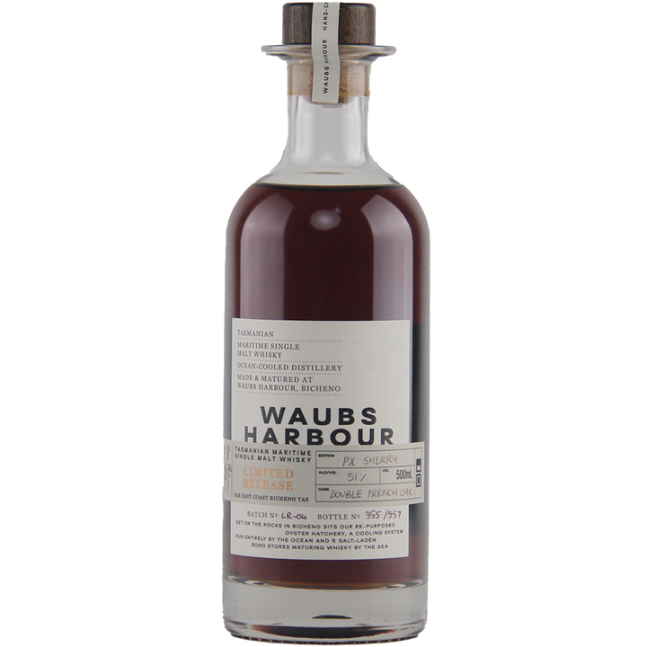 A bottle of Waubs Harbour PX Sherry Cask Single Malt Australian Whisky featuring dark brown liquid, a clear label with batch and bottle numbers, wooden cork stopper, and matured in PX Sherry and French oak casks.