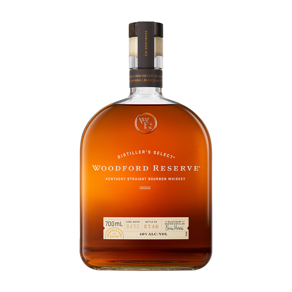 A bottle of Woodford Reserve Kentucky Straight Bourbon Whiskey featuring a brown cap, clear label, and amber liquid is shown on a plain white background—a renowned small-batch bourbon.