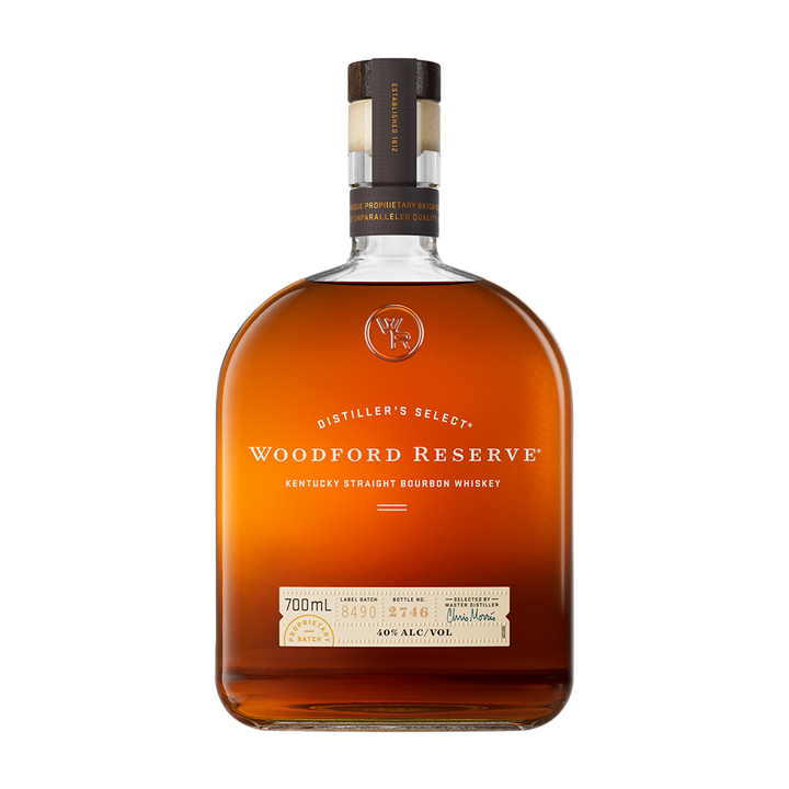 A bottle of Woodford Reserve Kentucky Straight Bourbon Whiskey featuring a brown cap, clear label, and amber liquid is shown on a plain white background—a renowned small-batch bourbon.