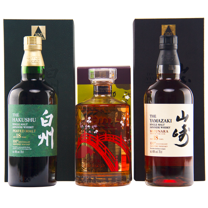 Three bottles—Yamazaki 18, Hakushu 18, and the Hibiki 100th Anniversary Set—are displayed in front of their boxes.