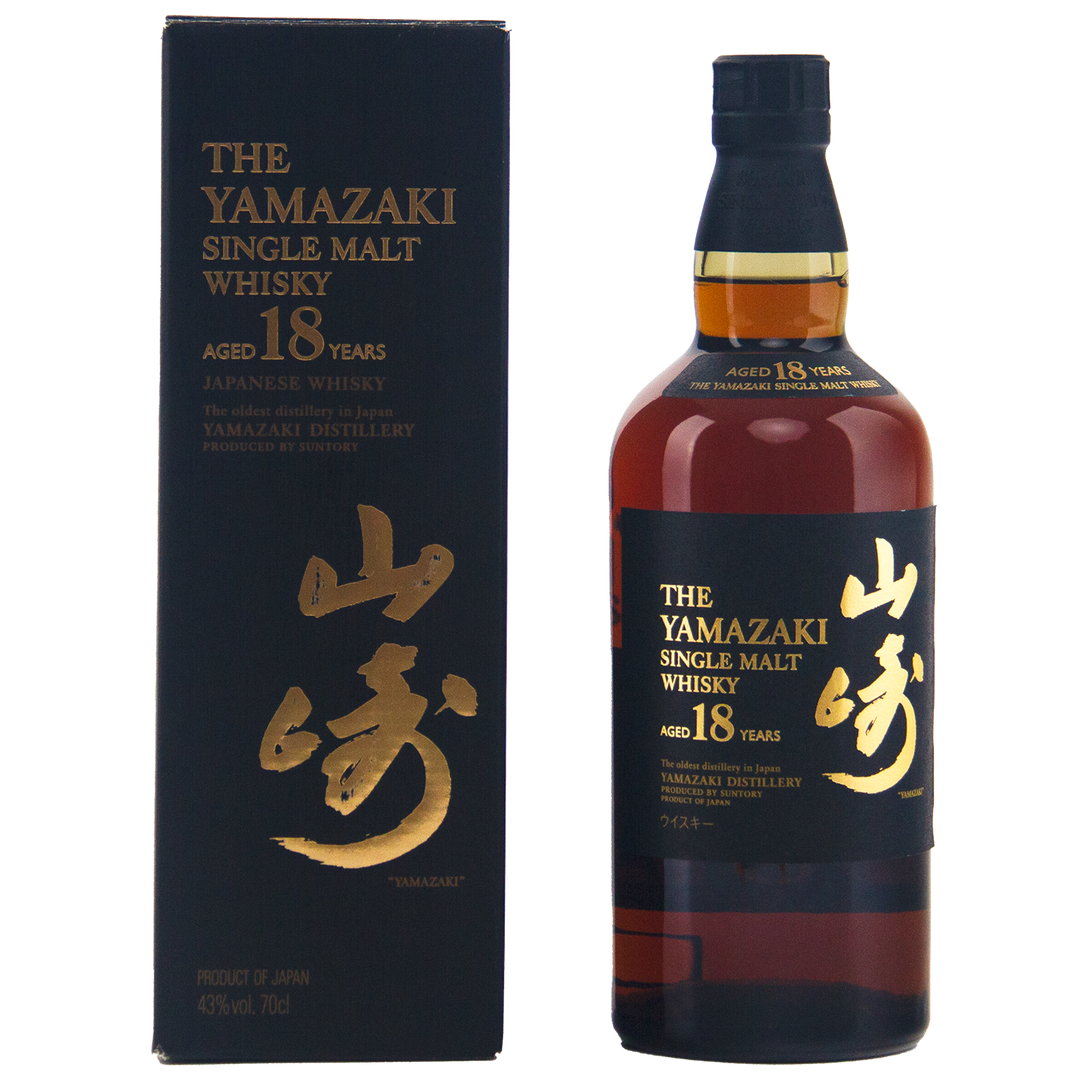 A bottle of Yamazaki 18 Year Old Japanese Single Malt Whisky stands next to its black and gold box adorned with Japanese characters. The bottle contains rich, dark amber single malt whisky.