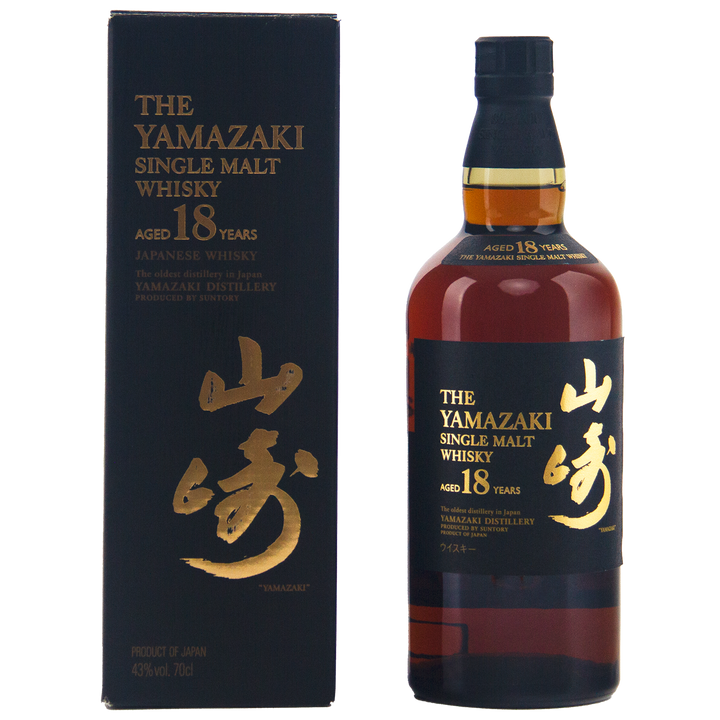 A bottle of Yamazaki 18 Year Old Japanese Single Malt Whisky stands next to its black and gold box adorned with Japanese characters. The bottle contains rich, dark amber single malt whisky.