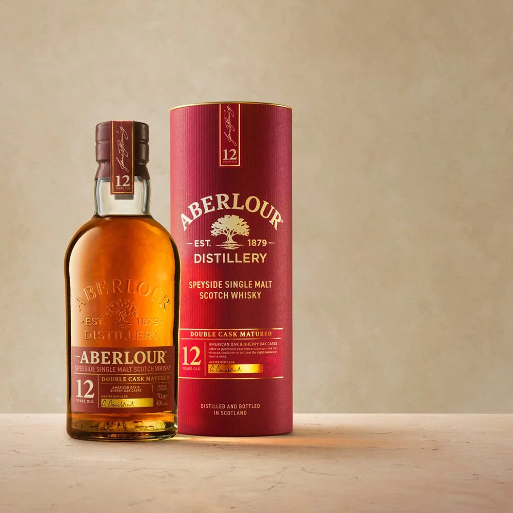 Aberlour whisky bottle and packaging on a wooden surface with a beige background