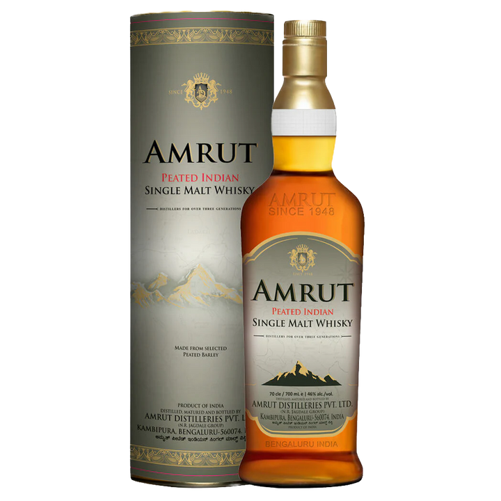 A bottle of Amrut Peated Indian Single Malt Whisky stands next to its cylinder, both adorned with mountain art and gold, black, and red text on a cream background—an elegant display for this peated single malt.