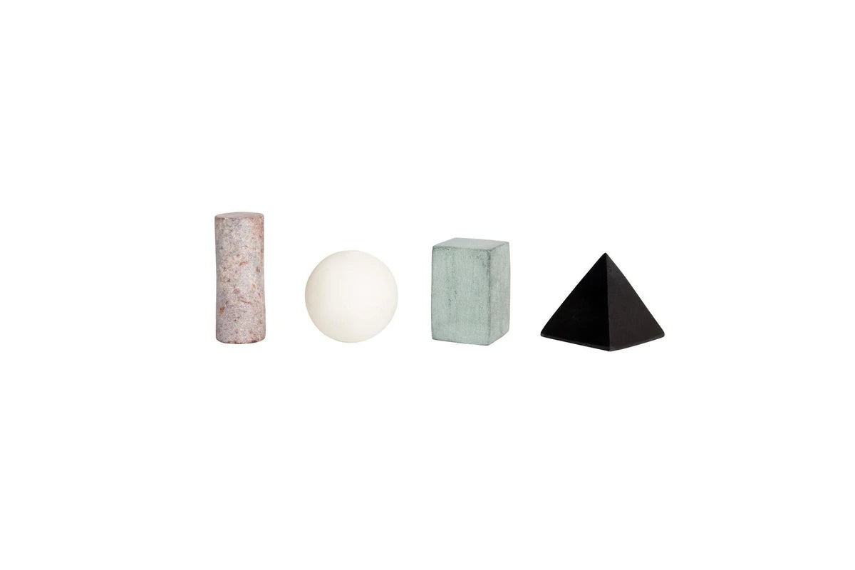 Four minimalist geometric decorative objects on a white background: a pink marble cylinder, a white sphere, a pale green marble cube, and a black pyramid.