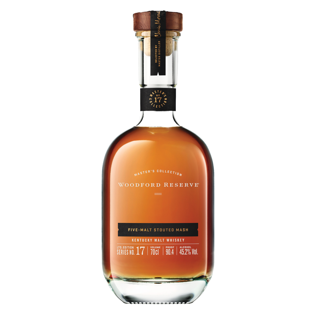 A bottle of Woodford Reserve Five Malt Stout Bourbon Whiskey Master Collection, with a clear label and wooden cork, filled with rich amber bourbon.