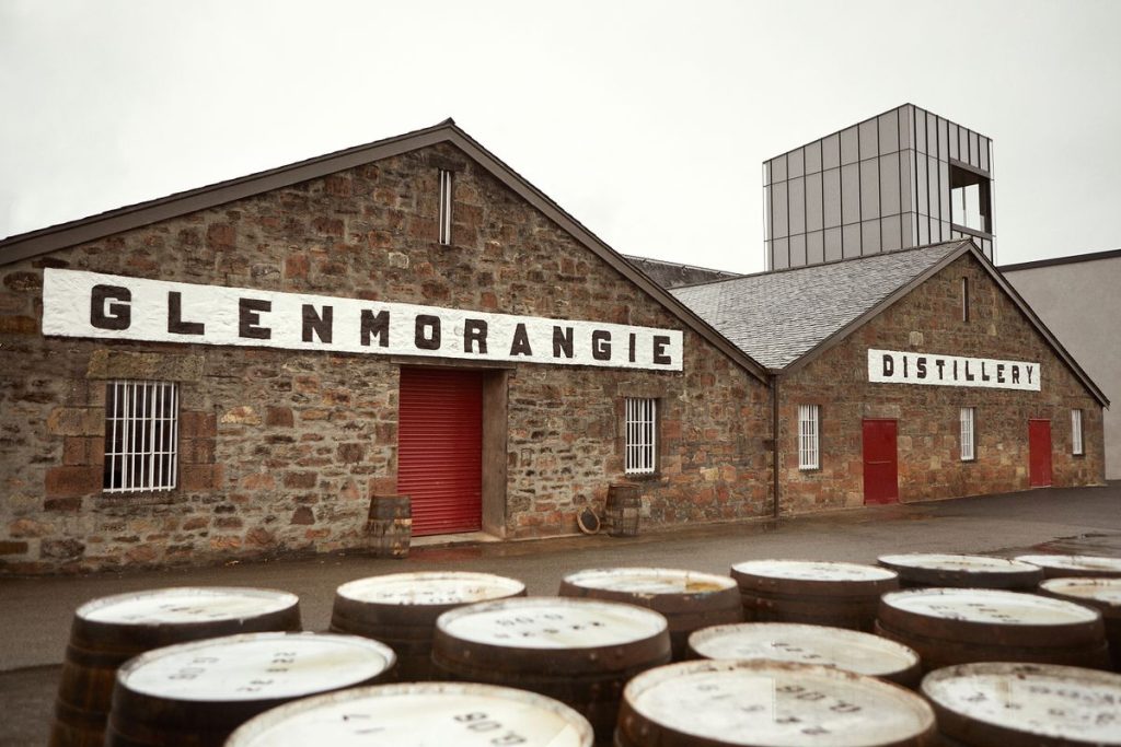 Glenmorangie distillery with whisky barrels in the foreground