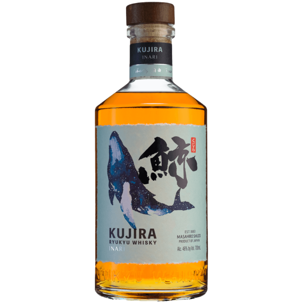 A bottle of Kujira Ryukyu Inari Japanese Whisky with amber liquid, crafted as a Japanese single grain whisky using Okinawan black Koji. It features a blue whale illustration, Japanese calligraphy, a wooden cap, and a blue neck label.