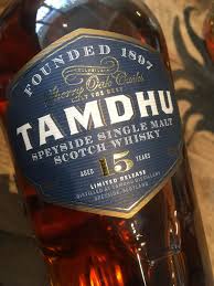 Tamdhu whisky bottle with gold label on a dark background